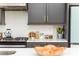 Stylish kitchen with quartz countertops, gray cabinetry, and stainless steel appliances at 1371 Walking Way, Atlanta, GA 30316