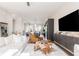 Bright, open-concept living area with modern furnishings, a sleek entertainment center and a view into the kitchen at 1371 Walking Way, Atlanta, GA 30316