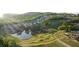 Aerial view showcasing a lovely neighborhood with a tranquil lake among green pastures at 235 Laurel Vista Dr, Canton, GA 30114