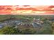 Beautiful sunset over the neighborhood with homes nestled among rolling green hills and lush trees at 235 Laurel Vista Dr, Canton, GA 30114