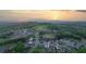 Breathtaking aerial view captures the community, nestled amidst trees and a mountain range, with a scenic sunset at 235 Laurel Vista Dr, Canton, GA 30114