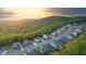 Stunning aerial view showcases a neighborhood nestled amidst lush green hills and a vibrant sunset backdrop at 235 Laurel Vista Dr, Canton, GA 30114