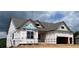 New construction home featuring gray shingles, framed windows, and a two-car garage at 235 Laurel Vista Dr, Canton, GA 30114