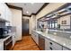 Modern kitchen with stainless steel appliances, granite counters, white cabinets, and hardwood floors at 235 Laurel Vista Dr, Canton, GA 30114
