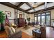 Inviting living room with hardwood floors, coffered ceiling, and comfortable seating near doors to the outside at 235 Laurel Vista Dr, Canton, GA 30114