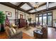 Comfortable living room features an elegant coffered ceiling, American flag, stylish furniture, and a view to the outside patio at 235 Laurel Vista Dr, Canton, GA 30114