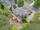 An elevated view of the home reveals a backyard with a fire pit and a tranquil water feature at 295 River Laurel Way, Woodstock, GA 30188