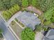 A lovely aerial view of the home showing the roof, driveway, landscaping, and surrounding neighborhood at 295 River Laurel Way, Woodstock, GA 30188