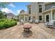 Inviting back exterior featuring a stone patio with seating and landscaped yard at 295 River Laurel Way, Woodstock, GA 30188