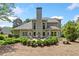 This home features a lovely backyard with manicured landscaping and an outdoor seating area at 295 River Laurel Way, Woodstock, GA 30188