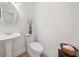 A powder room featuring a decorative sink, toilet, wood accents and modern fixtures at 295 River Laurel Way, Woodstock, GA 30188