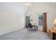 Light-filled bedroom with vaulted ceilings, neutral carpet, and a desk near two windows at 295 River Laurel Way, Woodstock, GA 30188