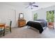 Bright bedroom has a bed, two windows, dresser and nightstand, with a door on the left at 295 River Laurel Way, Woodstock, GA 30188