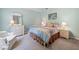 Charming bedroom features soft blue walls, a bed, and a white wicker dresser and nightstand at 295 River Laurel Way, Woodstock, GA 30188