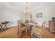 Elegant dining room features hardwood floors, stylish furnishings, a chandelier and natural lighting at 295 River Laurel Way, Woodstock, GA 30188