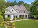 Charming two-story home boasts beautiful landscaping, a brick facade and a welcoming front porch at 295 River Laurel Way, Woodstock, GA 30188