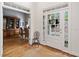 Bright foyer with natural light from a multi-paneled glass door, hardwood floors, and an adjacent dining room at 295 River Laurel Way, Woodstock, GA 30188