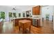 An open concept kitchen with wood cabinets, a butcher block, stainless steel appliances, and hardwood flooring at 295 River Laurel Way, Woodstock, GA 30188
