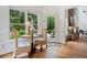 A cozy eat-in kitchen with large windows and hardwood floors, offering serene backyard views at 295 River Laurel Way, Woodstock, GA 30188