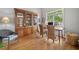 Office features natural light, hardwood floors, stylish seating, and a built-in display cabinet at 295 River Laurel Way, Woodstock, GA 30188