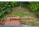 An aerial view showcasing the wooden deck, green lawn, and mature trees surrounding the house, a private outdoor retreat at 4052 Shawnee Ne Ln, Brookhaven, GA 30319