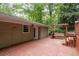 A cozy deck area featuring a wooden swing with an outdoor entrance, offering a great space for relaxation at 4052 Shawnee Ne Ln, Brookhaven, GA 30319
