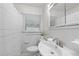 Bathroom featuring a sink, toilet, shower with curtain, and built-in medicine cabinet at 4052 Shawnee Ne Ln, Brookhaven, GA 30319