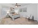 Cozy bedroom with a ceiling fan, neutral carpet, and natural light from two windows at 4052 Shawnee Ne Ln, Brookhaven, GA 30319