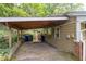 A spacious carport offering convenient parking and protection from the elements, located on the side of the house at 4052 Shawnee Ne Ln, Brookhaven, GA 30319