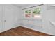 A closet with hardwood floors, white wood-paneled walls, wire shelving and a window providing natural light at 4052 Shawnee Ne Ln, Brookhaven, GA 30319