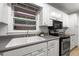 Well-lit kitchen with white cabinets, stainless steel appliances, and a window above the sink at 4052 Shawnee Ne Ln, Brookhaven, GA 30319