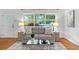 Inviting living room with hardwood floors, a gray sofa, and a view to the outside at 4052 Shawnee Ne Ln, Brookhaven, GA 30319