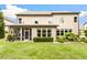 Spacious backyard featuring lush greenery, a screened porch, and manicured lawn at 4779 Moon Hollow Ct, Buford, GA 30519