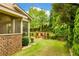Beautiful backyard featuring a screened porch, firepit and lush greenery at 4779 Moon Hollow Ct, Buford, GA 30519
