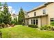 Beautiful backyard featuring lush greenery, a screened porch, and manicured lawn at 4779 Moon Hollow Ct, Buford, GA 30519