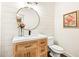 Stylish half-bath featuring shiplap walls, a modern vanity, and a round mirror at 4779 Moon Hollow Ct, Buford, GA 30519