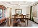 Formal dining room with coffered ceiling, hardwood floors, and a large window at 4779 Moon Hollow Ct, Buford, GA 30519