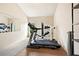 Bright home gym featuring mirrored wall, treadmill, and weight machine at 4779 Moon Hollow Ct, Buford, GA 30519