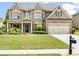 Charming two-story brick home with a well-manicured lawn and attached two-car garage at 4779 Moon Hollow Ct, Buford, GA 30519