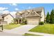 Beautiful two-story home featuring a lush lawn, two-car garage, and a welcoming facade at 4779 Moon Hollow Ct, Buford, GA 30519