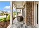 Charming covered front porch with stone tiles and a cozy outdoor seating area at 4779 Moon Hollow Ct, Buford, GA 30519