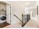 Upstairs hallway featuring access to the laundry room and bedrooms at 4779 Moon Hollow Ct, Buford, GA 30519