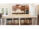 Kitchen island features granite countertops, a sink, and space for barstool seating with an open view to the outdoors at 4779 Moon Hollow Ct, Buford, GA 30519