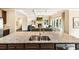 Modern kitchen with granite countertops, stainless steel appliances, and a view into the living room at 4779 Moon Hollow Ct, Buford, GA 30519