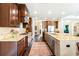 A full kitchen featuring stainless steel appliances, dark wood cabinets, an island, and granite countertops at 4779 Moon Hollow Ct, Buford, GA 30519