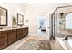 Spacious main bathroom with a double vanity, tile floors, and a glass-enclosed shower at 4779 Moon Hollow Ct, Buford, GA 30519