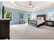 Expansive main bedroom showcases neutral carpet, light blue walls, and elegant dark wood furniture at 4779 Moon Hollow Ct, Buford, GA 30519