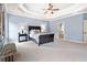 Spacious main bedroom features a tray ceiling, neutral carpet, and light blue walls with a sitting area at 4779 Moon Hollow Ct, Buford, GA 30519