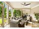 Screened in patio with ceiling fan, wicker furniture, outdoor grill and view of the private backyard at 4779 Moon Hollow Ct, Buford, GA 30519