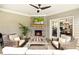Covered patio with brick fireplace, ceiling fan, outdoor seating, and views of the dining area at 4779 Moon Hollow Ct, Buford, GA 30519